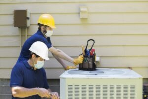 two-technicians-standing-over-outdoor-ac-unit